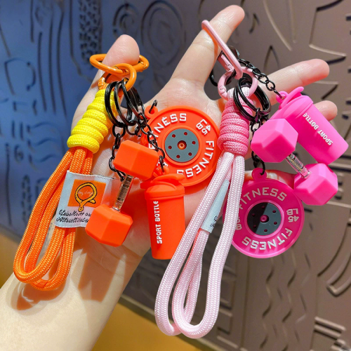 Zdjęcie Brelok fitness w kształcie sztangi – silikonowy breloczek do kluczy z kółkami obciążeniowymi, idealny prezent dla miłośników siłowni i trenerów