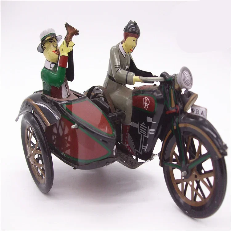 Image of Vintage Wind-Up Tin Toy Collection: Classic Clockwork Metal Man Riding Tricycle – Retro Mechanical Toy for Kids and Collectors